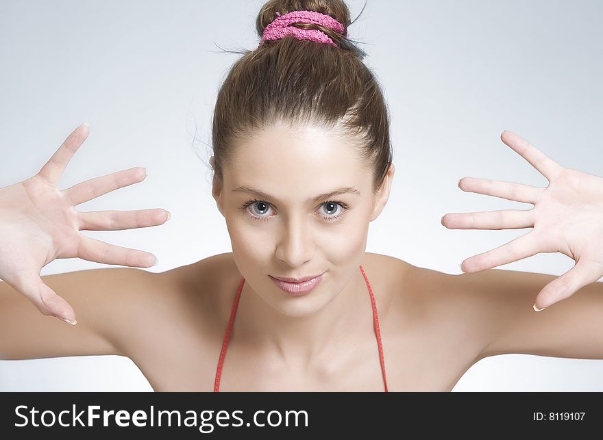 High key portrait of young woman on gray  back