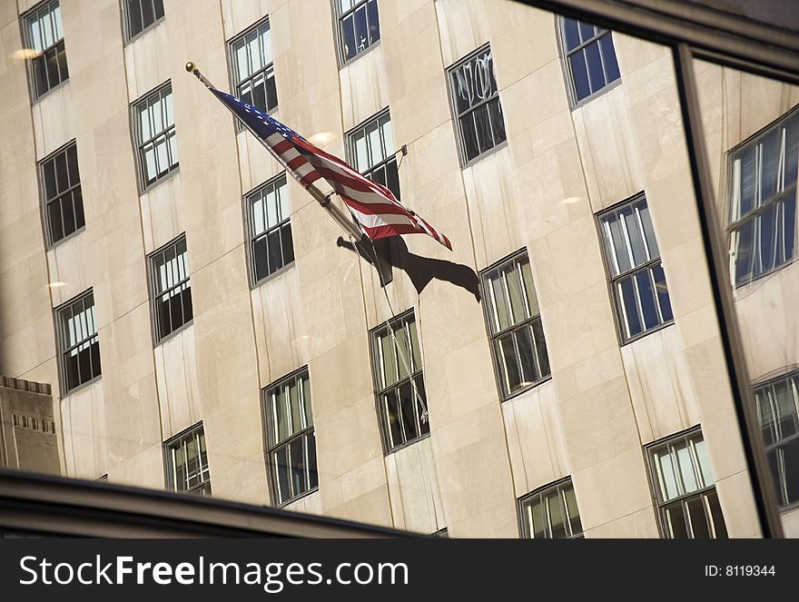 USA flag reflectod on a window at NYC