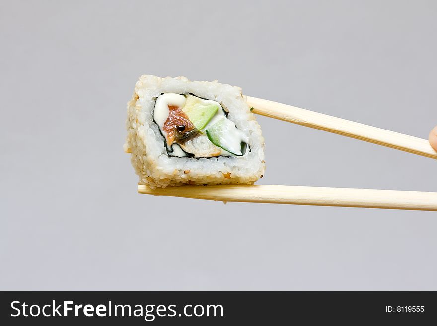 Sushi and chopsticks on the neutral background