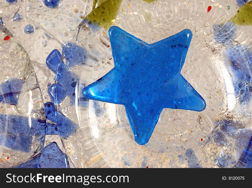 Blue glass star, close-up abstract composition