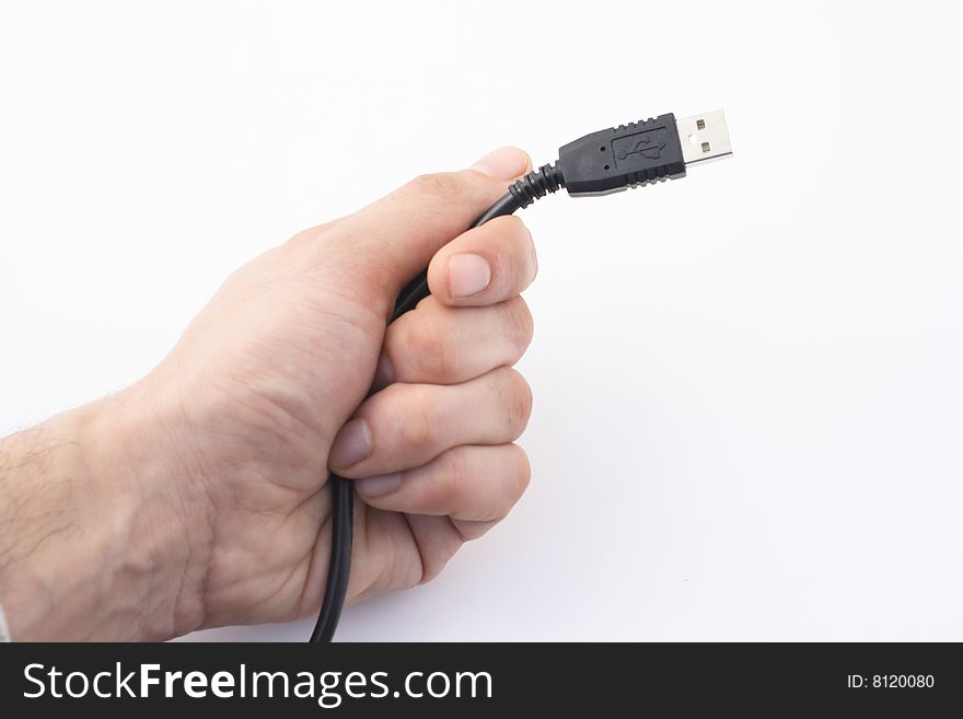 Hand with black cable on white background