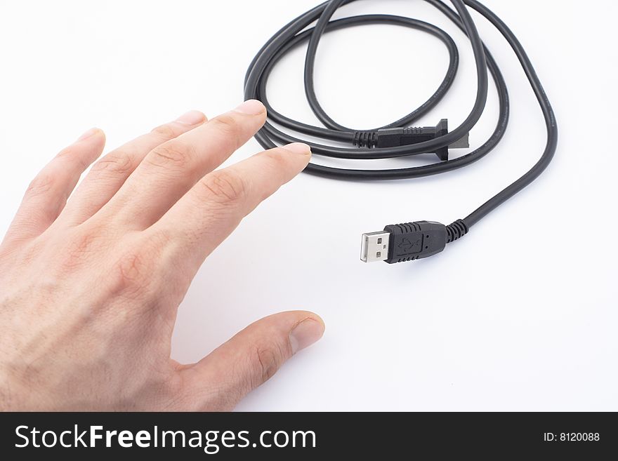Hand and black cable on white background