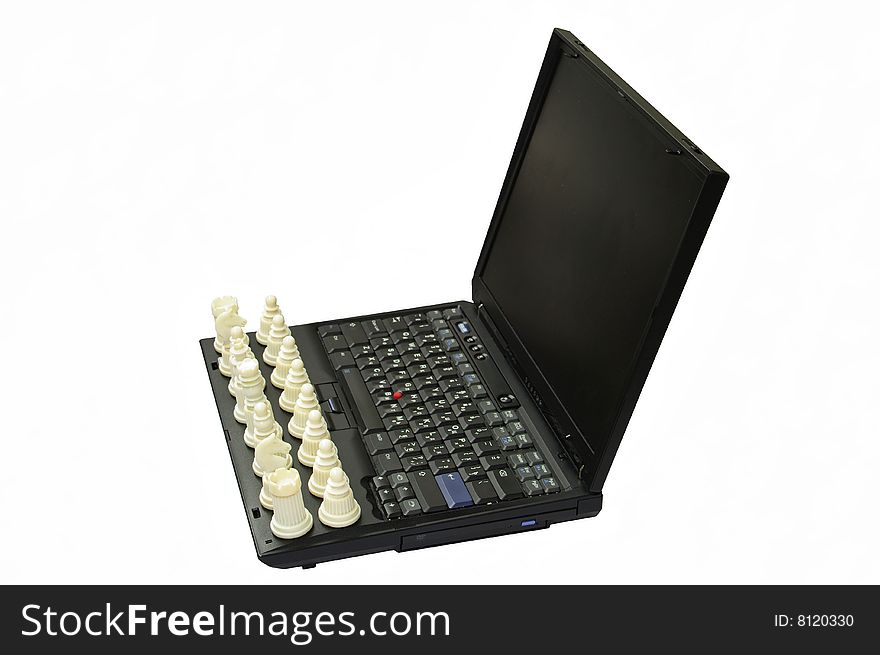 Chess on the keyboard of computer.Computer on a white background.