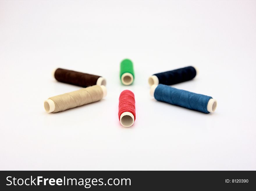 Colored rolls of thread on a white background. Colored rolls of thread on a white background