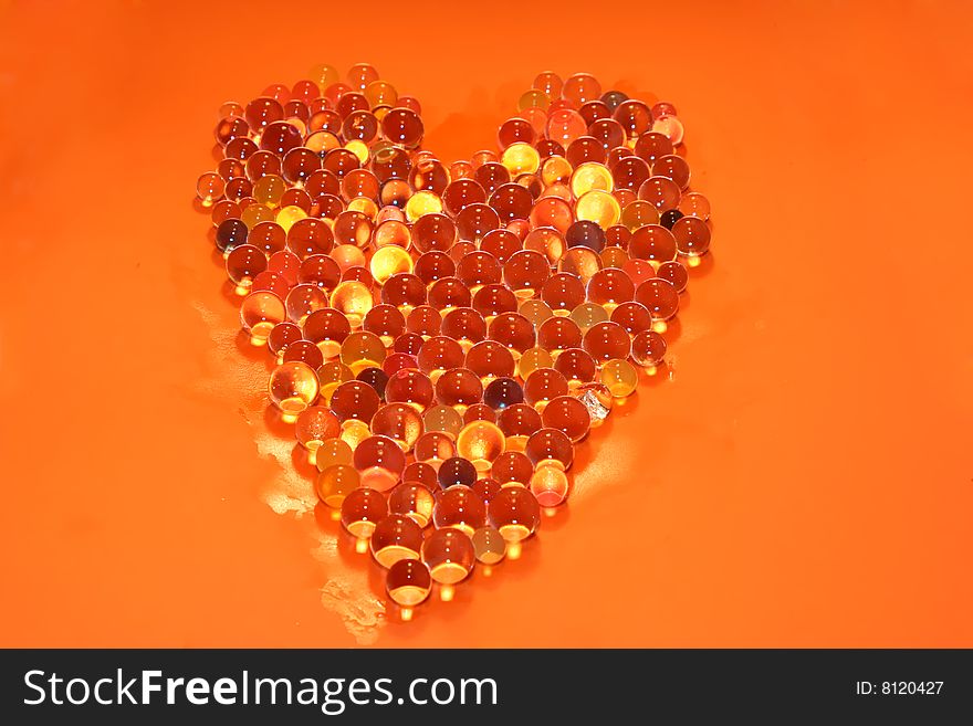 Water bubbles making a heart in a orange background. Water bubbles making a heart in a orange background