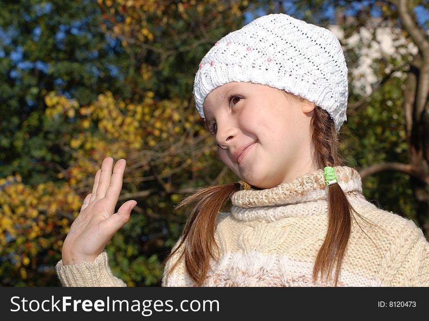 Portrait of little girl in the white stocking little cap