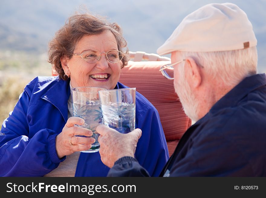 Happy Senior Adult Couple Enjoying Drinks Together. Happy Senior Adult Couple Enjoying Drinks Together.