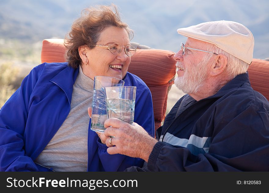 Happy Senior Adult Couple Enjoying Drinks Together. Happy Senior Adult Couple Enjoying Drinks Together.