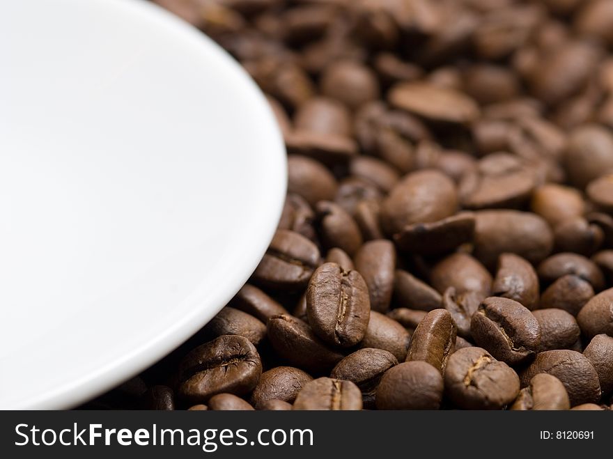 Saucer and coffee beans background