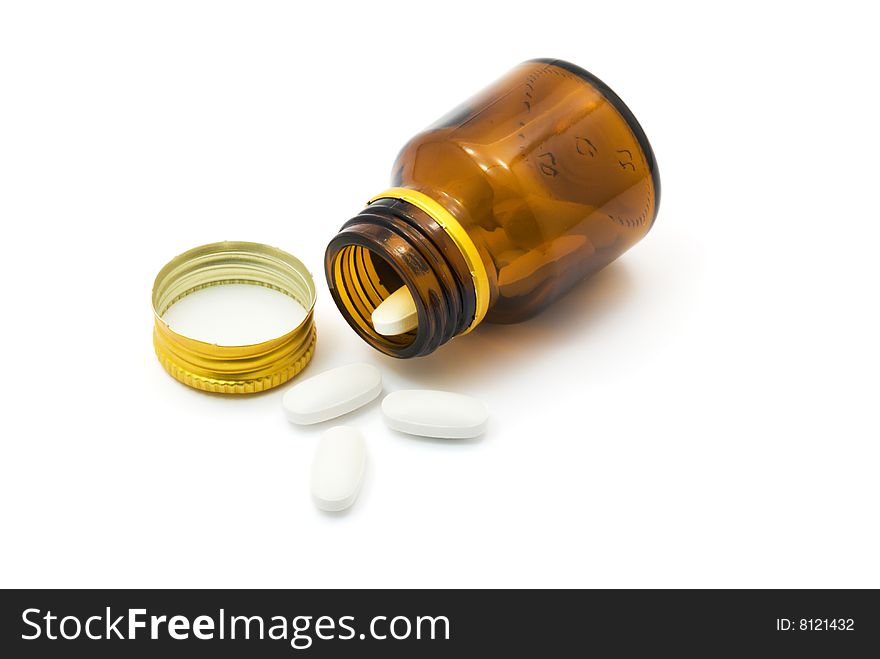 Transparent bottle with pills over white background