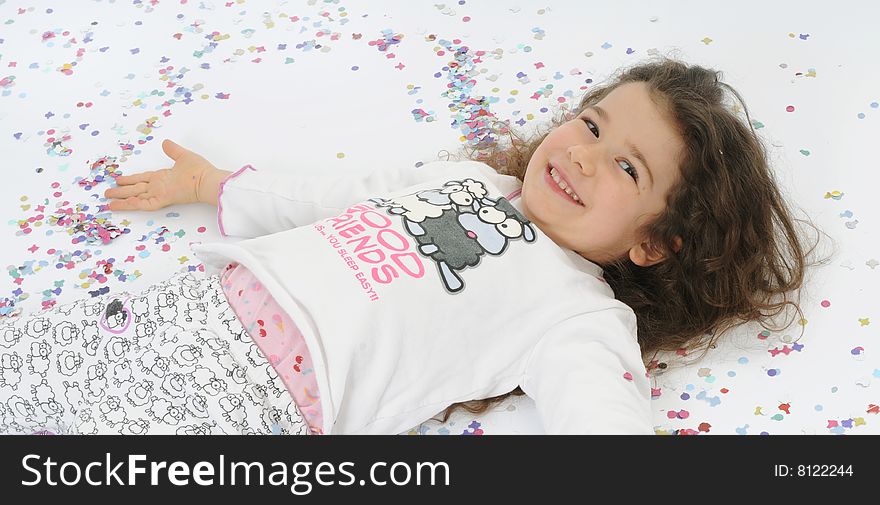 A little girl playing with carnival confetti. A little girl playing with carnival confetti