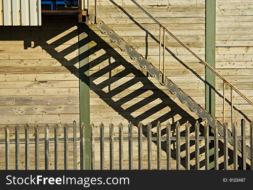 Shadows and lines making patterns on external stairway of factory. Shadows and lines making patterns on external stairway of factory.