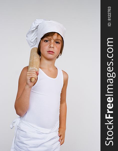 Young baker boy holding a rolling pin