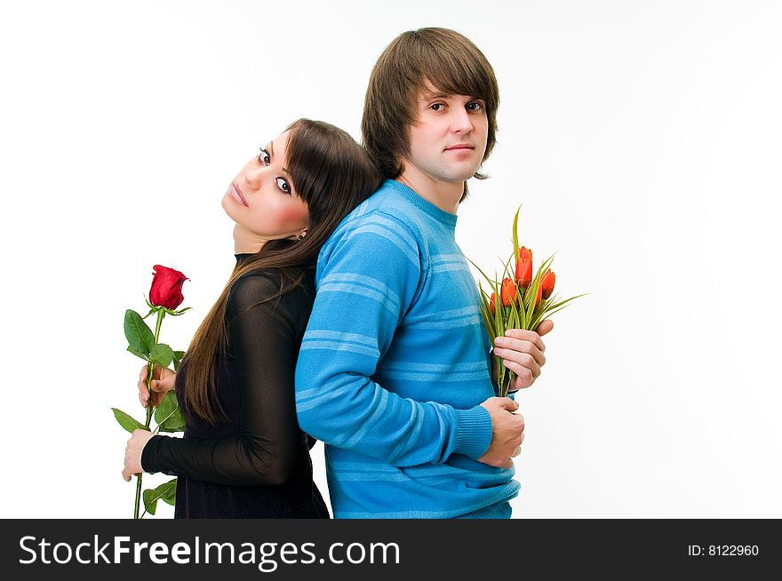 Young couple with rose and tulips, isolated on white background