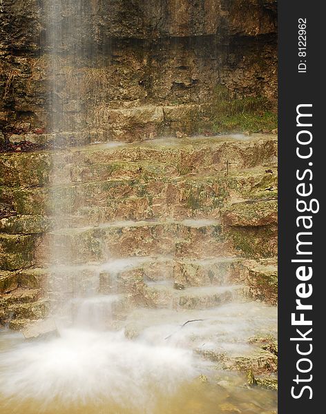 This image is of a natural waterfall at a local state park. The wall behind the falls form steps at the base of the falls. this image shows the steps behind the falls. This image is of a natural waterfall at a local state park. The wall behind the falls form steps at the base of the falls. this image shows the steps behind the falls.