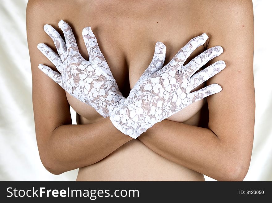 Breasts covered with hands in sexy gloves