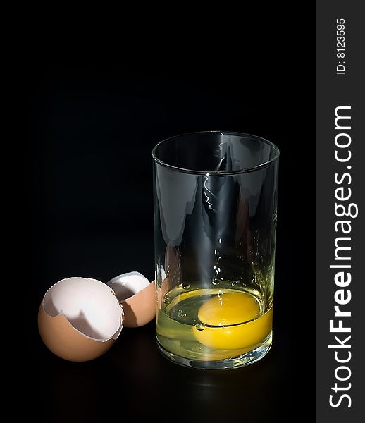 Transparent glass with egg inside and egg-shell