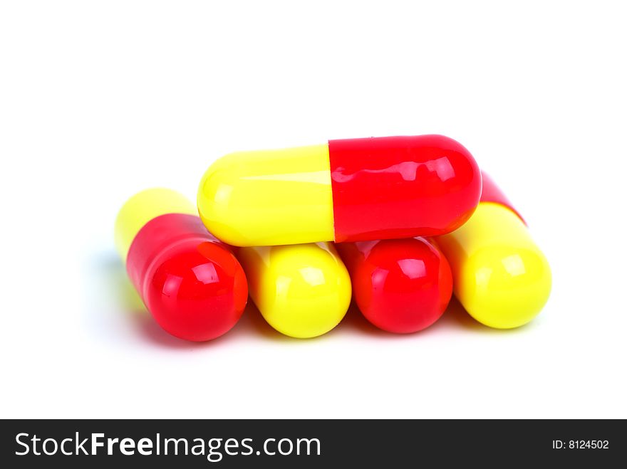 Some yellow-red capsules isolated on the white background
