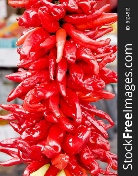 A bunch of hot, red peppers at an outdoor market. A bunch of hot, red peppers at an outdoor market