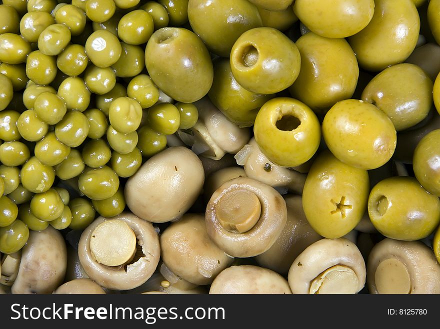 Background from olives, mushrooms and a green peas