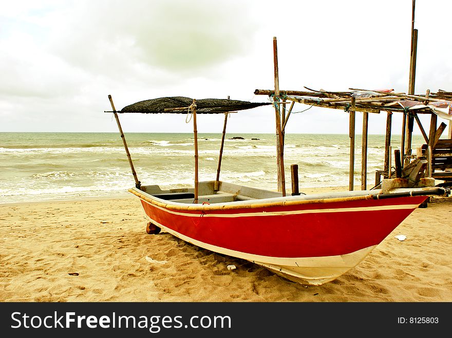 A wooden Malay fishing boat docked at the beach. See other similar images in my portfolio. A wooden Malay fishing boat docked at the beach. See other similar images in my portfolio.