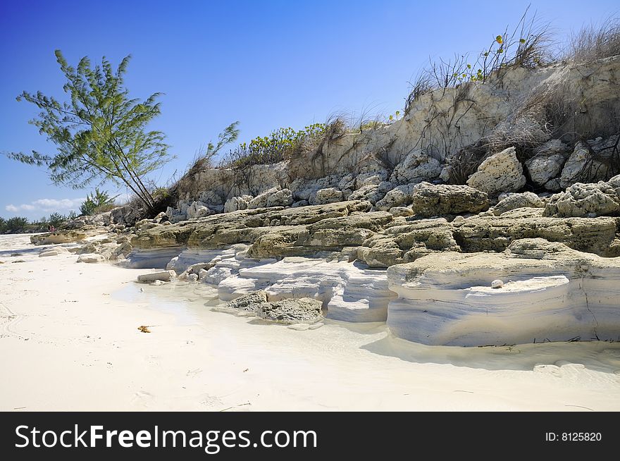 A view of tropical beach with rocks and vegetation - cayo guillermo, cuba. A view of tropical beach with rocks and vegetation - cayo guillermo, cuba