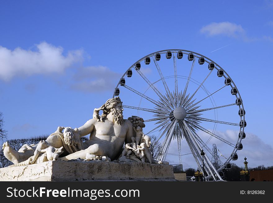 Classical sculpture and the rolling coaster, landmark of paris. Classical sculpture and the rolling coaster, landmark of paris