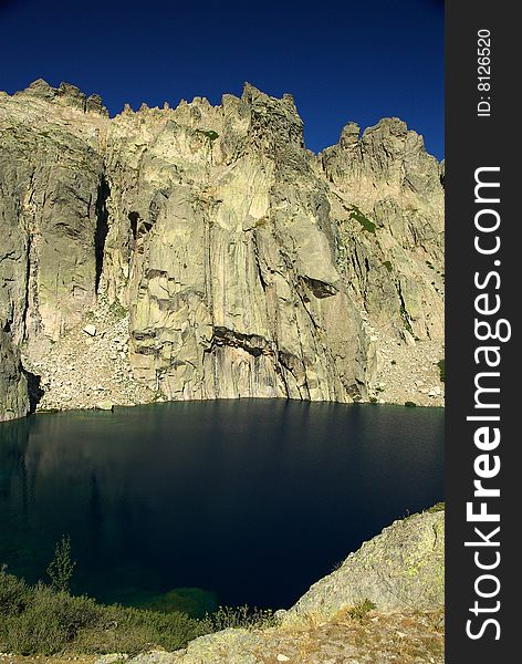 cliff above Capitello lake in Corsica. cliff above Capitello lake in Corsica