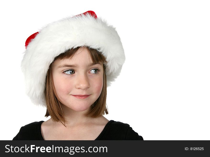 Cute girl in Santa hat, looking to the side at the copy space available