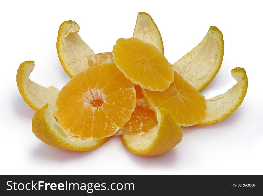 Slices of an orange on an orange peel. A white background.