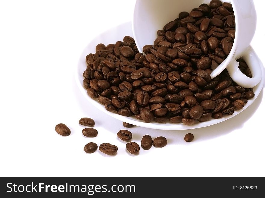 Coffee beans heap in white cup. Coffee beans heap in white cup
