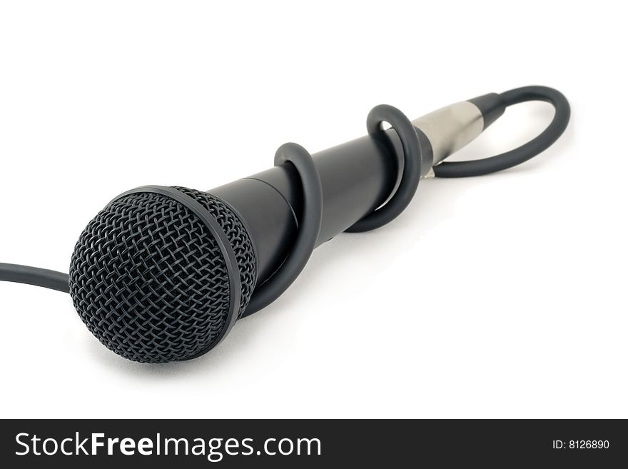 Microphone entangled with it's wire. White background.