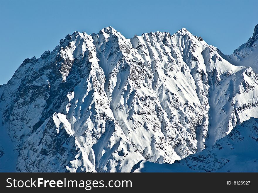 the white summits on the belledonne mountain in french alps. the white summits on the belledonne mountain in french alps