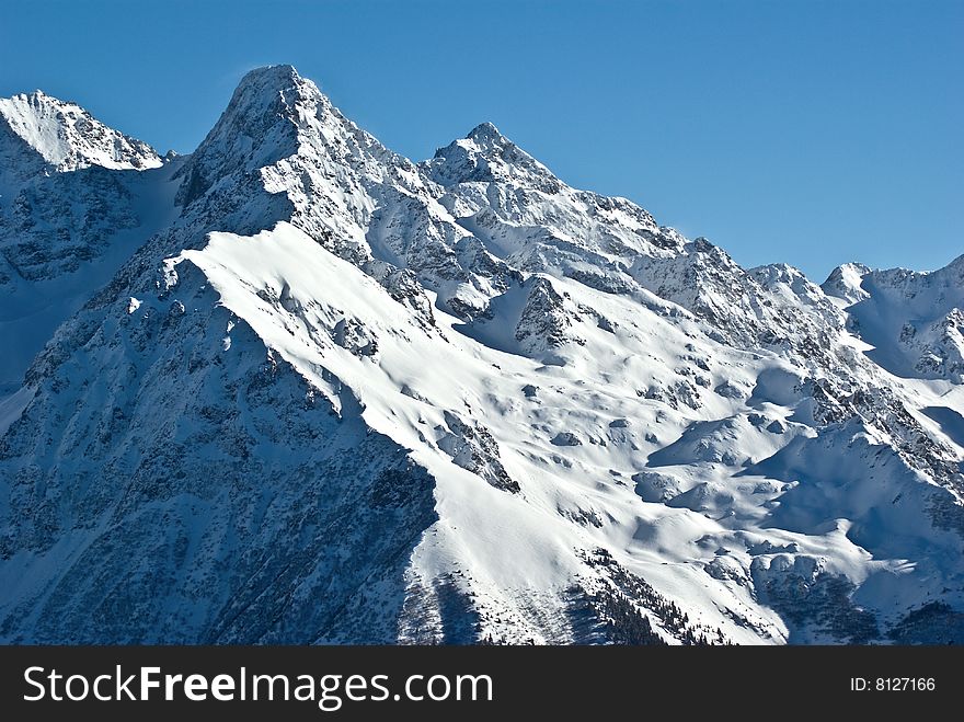 the white summits on the belledonne mountain in french alps. the white summits on the belledonne mountain in french alps