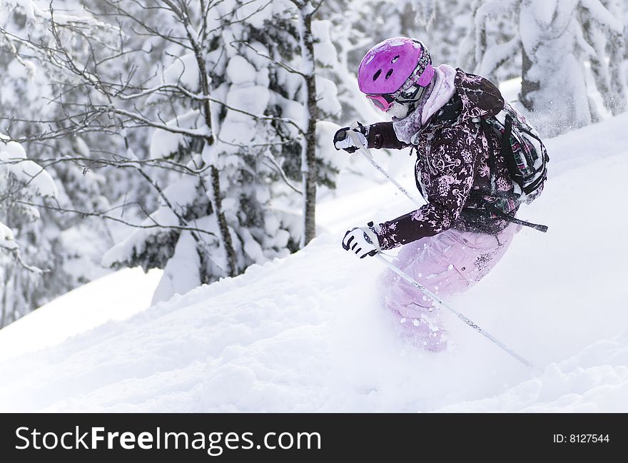 Girl riding on skis in the powder snow. Girl riding on skis in the powder snow