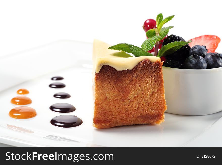 Cheese Cake with Fresh Berries Bowl and Green Mint. Isolated on White Background