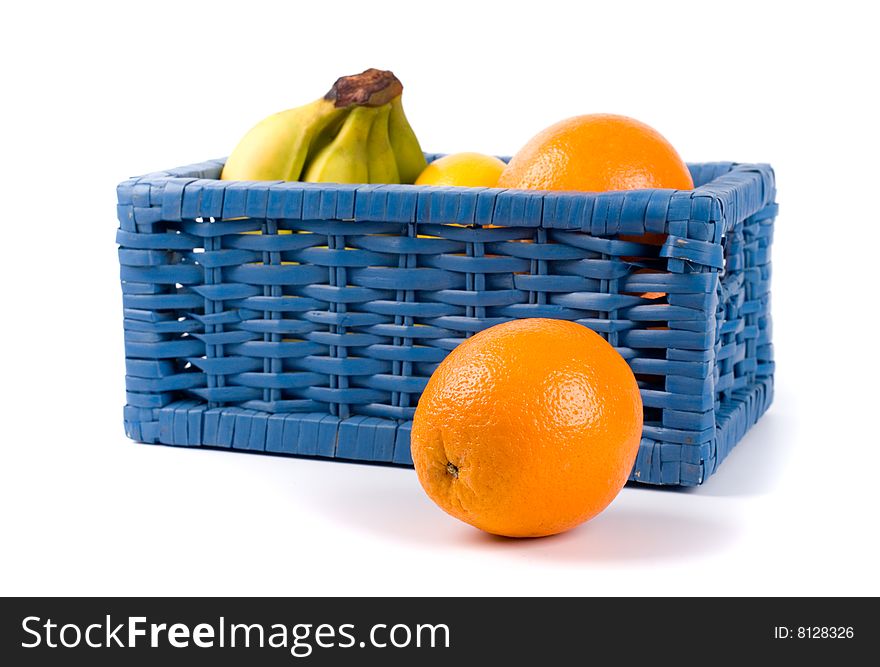 Blue basket with fruits on white background
