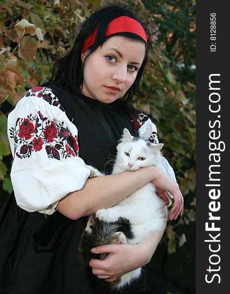 Village girl with a cat in Ukrainian clothes