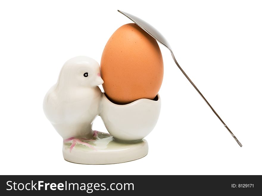 Egg and the spoon on a white background