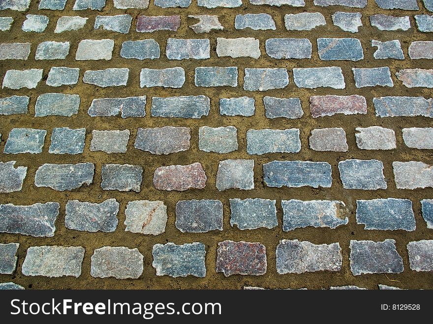 Street background made of grey granite stones