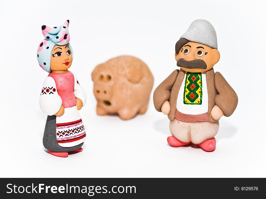 Man, woman and pig. Clay sculptures. National character, clothes, symbolism. Man, woman and pig. Clay sculptures. National character, clothes, symbolism.