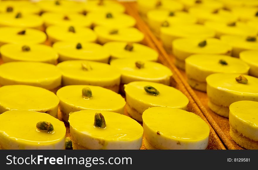 Trays of fresh sweet pistachio tarts with a pistachio nut in each one