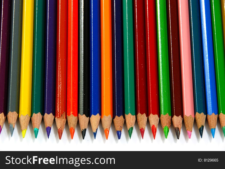 Colourful pencils line up over white. Colourful pencils line up over white