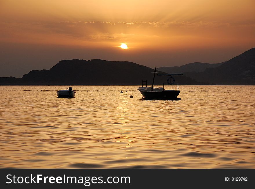 Two boats at sunset. Montenegro. Two boats at sunset. Montenegro