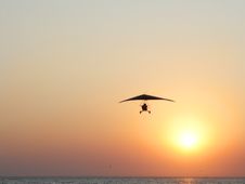 Hangglider In Action Against A Sea Sunset Stock Photo Hangglider In Action Against A Sea Sunset Stock Photo