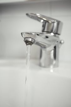 Water Tap With Focus On Water Coming Out Of Tap Royalty Free Stock Photos