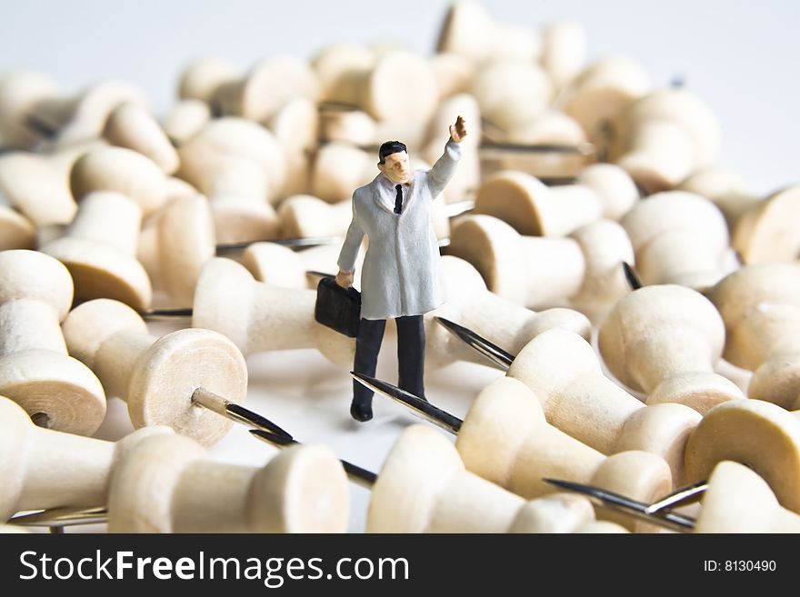 Businessman figurine placed with tacks. Businessman figurine placed with tacks