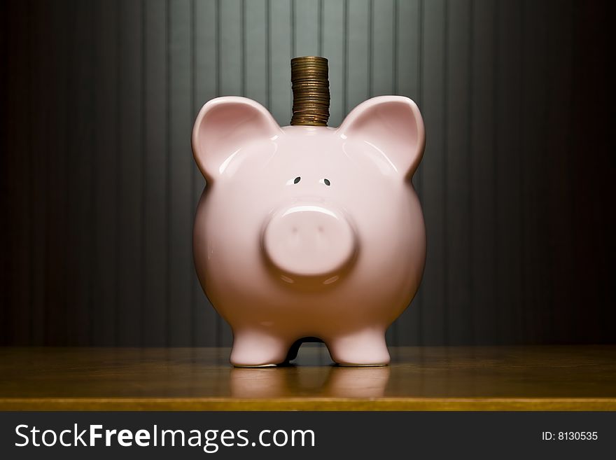 Stack of pennies placed on a piggy bank