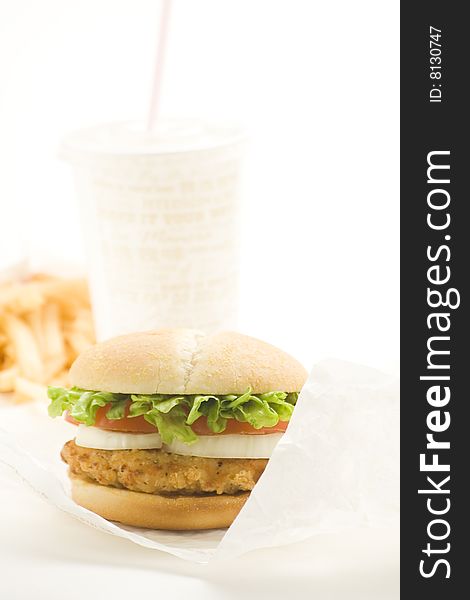 Crisp chicken burger with tomato onion cheese lettuce isolated. Crisp chicken burger with tomato onion cheese lettuce isolated