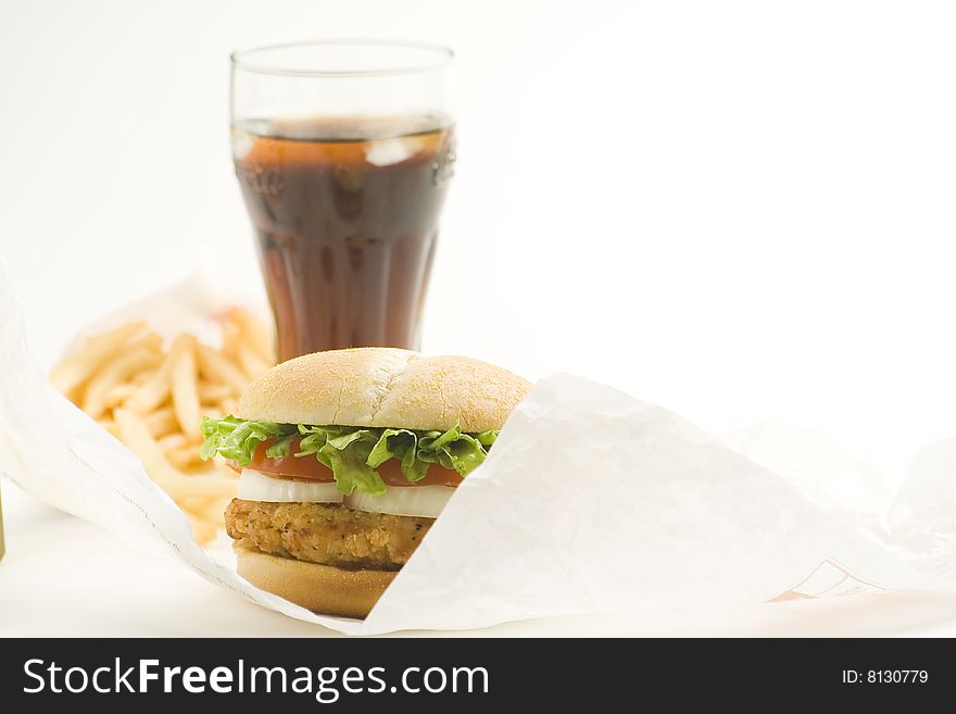 Crisp chicken burger with tomato onion cheese lettuce isolated. Crisp chicken burger with tomato onion cheese lettuce isolated